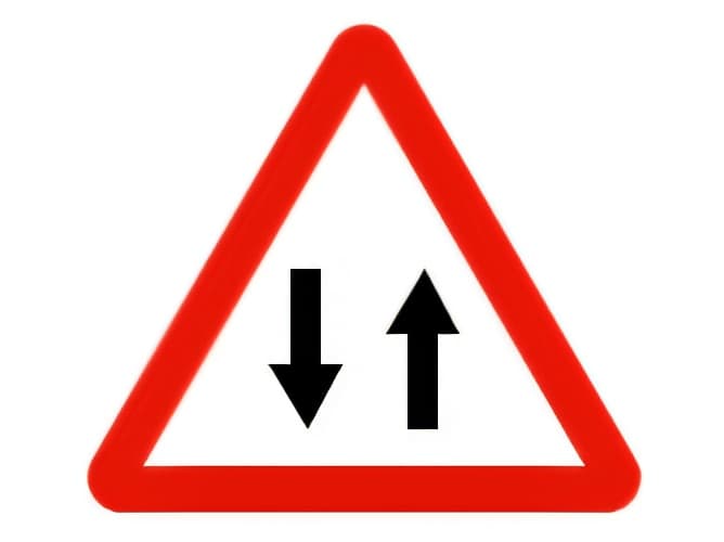 Riding our motorcycle on a two-way road, on which side should we leave a traffic island?