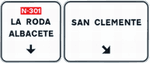 Signs over the carriageway on a conventional road. Immediate exit towards a conventional road and continuing direction