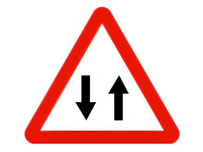 Riding our motorcycle on a two-way road, on which side must we leave a traffic island?